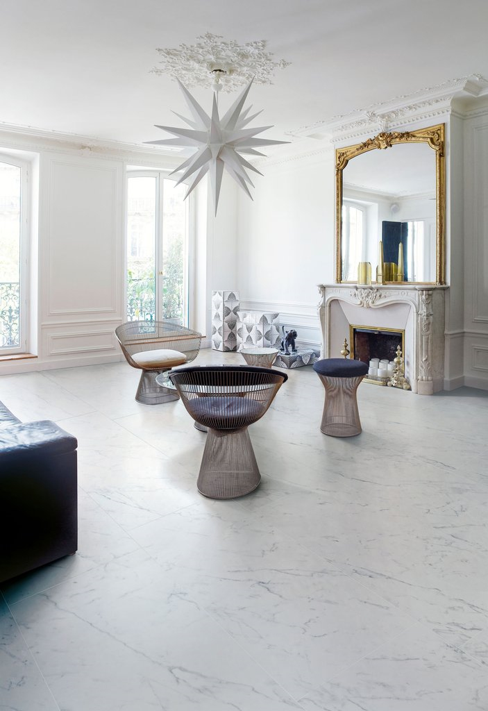 Arabescato porcelain tiles featured in living room with white walls