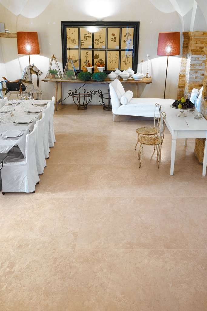 Beige Impero porcelain tiles featured in dining room with white furnishings