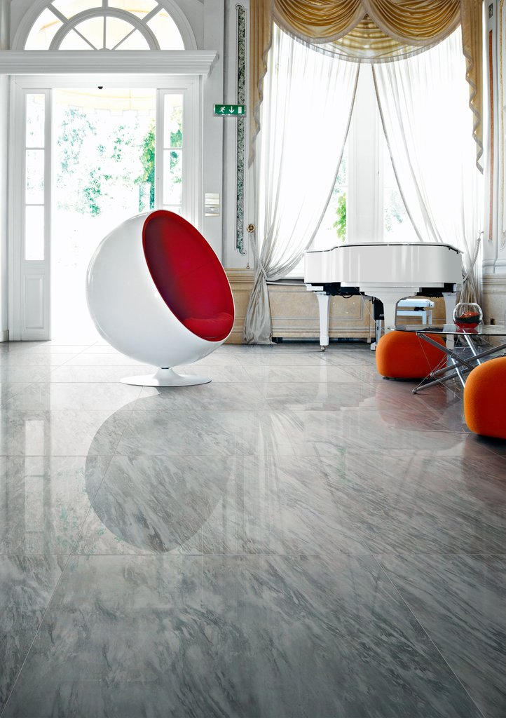 Ocean Grey porcelain tiles featured in living room with orange accents